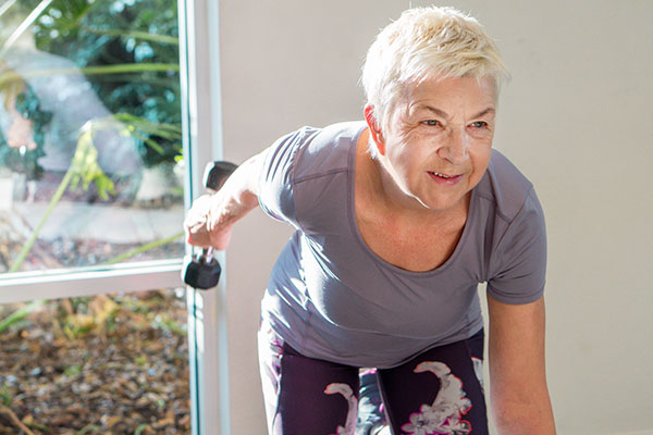an active senior woman exercising in the gym
